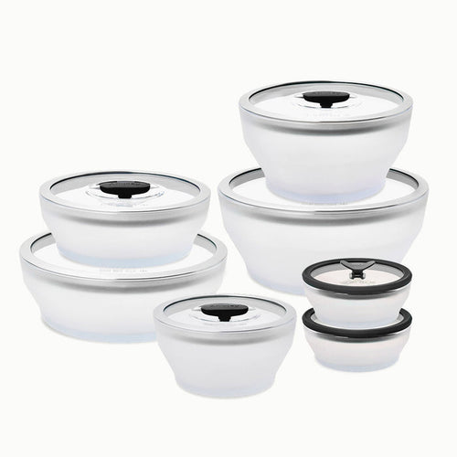 Fourteen-piece glass round dish set featuring clear containers with white lids and black seals, neatly arranged by size on a white background—an ideal addition for a plastic-free kitchen seeking stylish microwave-safe cookware.