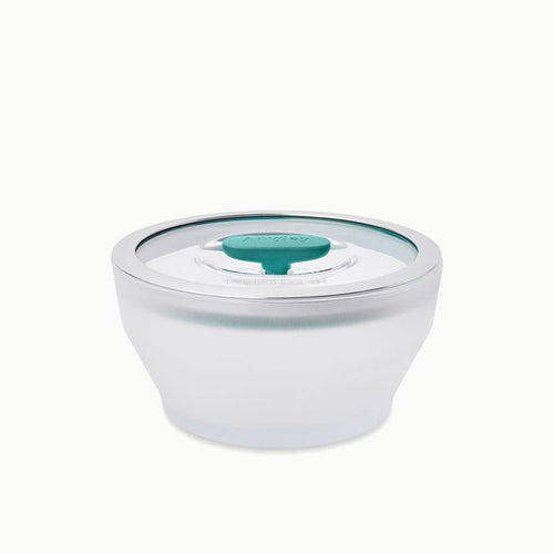 The 4-Cup Glass Round Deep Dish features frosted glass construction with a clear lid and a teal circular vent in the center, making it ideal for steaming vegetables or reheating leftovers in the microwave; shown on a white background.