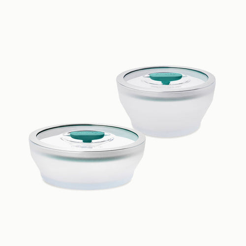 A 4-Piece Glass Round Dish Set featuring two silver, round food storage bowls with clear lids and green center seals is shown on a white background.