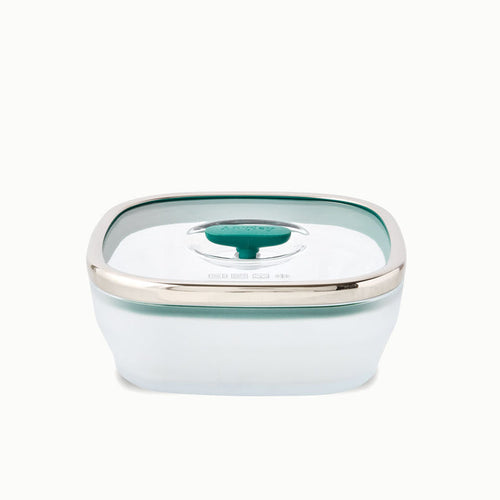 The 5.5-Cup Glass Square Shallow Dish is a transparent, square-shaped food storage container ideal for steaming asparagus in the microwave. It comes with a green-tinted, airtight lid accented by a silver rim and a dark green center tab.