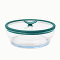 The 7-Cup Glass Round Shallow Dish is a clear, round glass food storage container with a teal plastic lid that features a vent in the center—ideal for reheating leftovers or steaming asparagus in the microwave.