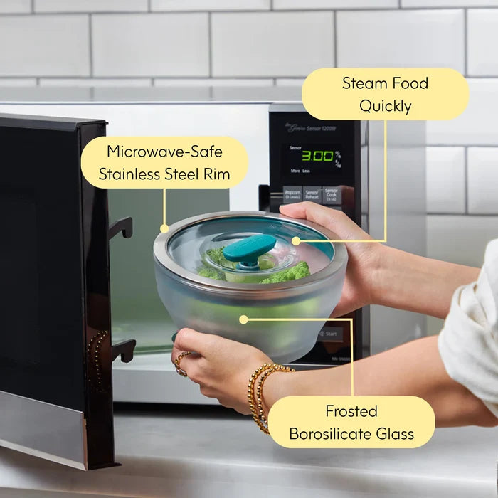 A person uses the 8-Piece Glass Round Dish Small Spaces Set in the microwave, highlighting how this set streamlines steaming food quickly and conveniently. Each dish features a frosted borosilicate glass bowl with a durable stainless steel rim and a plastic vented lid for safe, efficient heating. Thanks to these robust materials and practical design, the dishes are ideal both for cooking and as versatile glass food storage containers.