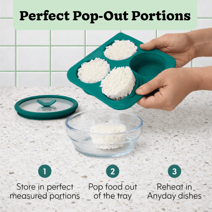 A hand pops a rice portion from the ½-Cup Anytime Freezer Tray Multipack’s teal silicone tray into a glass bowl on the counter, while the matching silicone lid rests nearby. Text highlights how easy it is to store, pop out, and reheat perfect portions—making meal prep and freezing food for later simple.