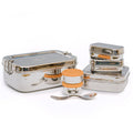 A set of stainless steel food containers including an Elephant Box 2 litre lunch box, small dressing pots with silicone lids, and a spork, all displayed on a white surface.