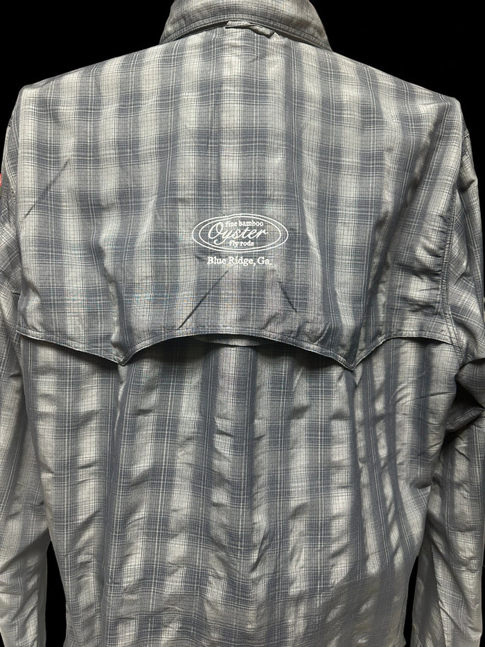 Simms Big Sky long sleeve shirt in black plaid featuring Oyster fly rods logo.