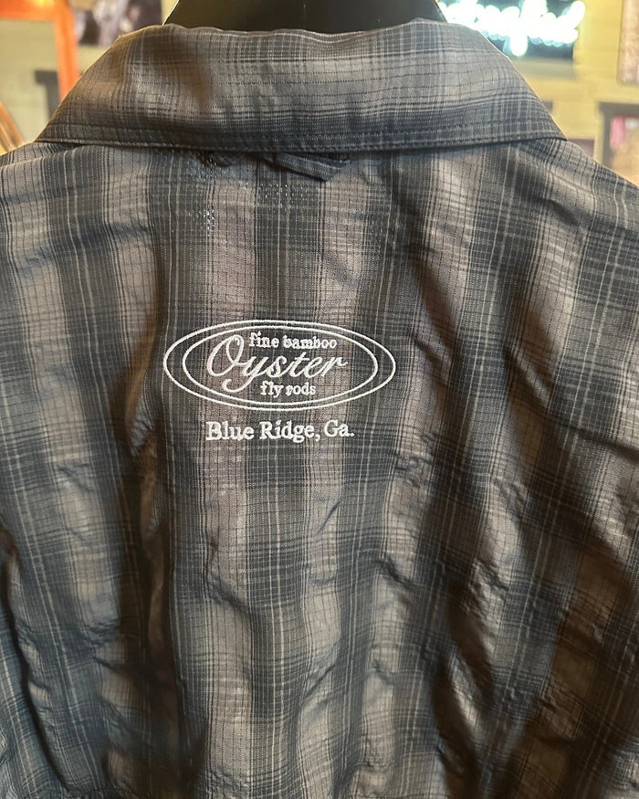 Simms Big Sky short sleeve fishing shirt in black plaid with Oyster fly rods logo.