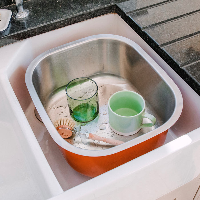 a metal washing up bowl or basin in a kitchen sink